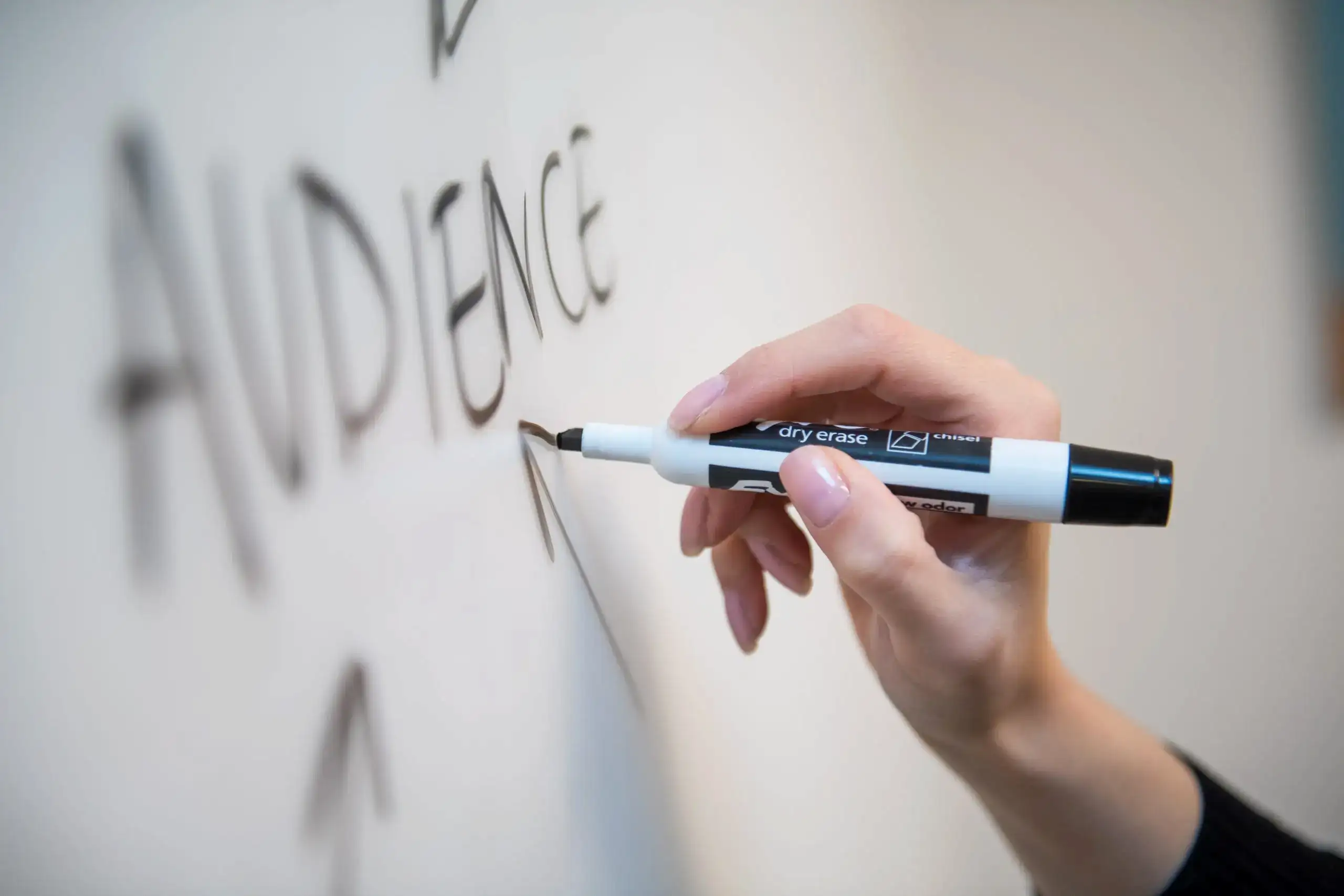 Person writing on a white board
